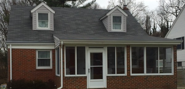 Brick front house with roof and singles.